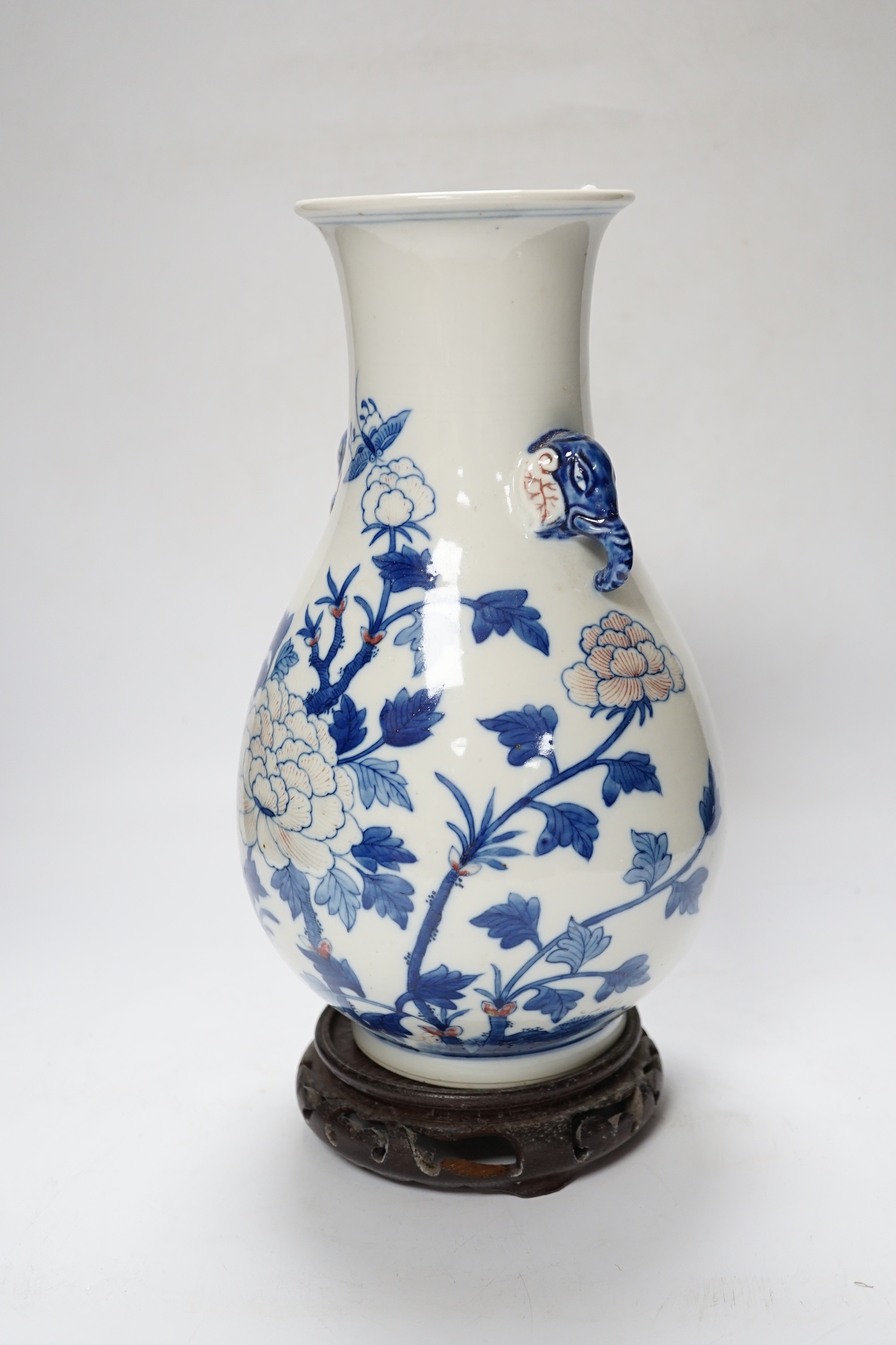 A Chinese underglaze blue and copper red pear shaped vase, on stand, 31cm high including stand